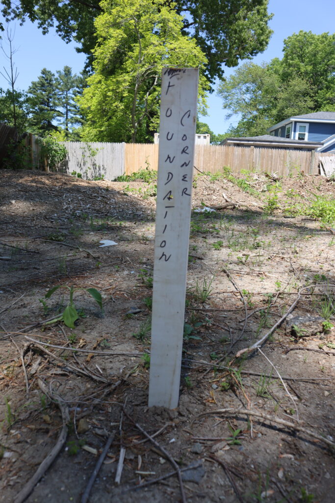 A post marks the corner of the foundation to be poured at the habitat for humanity site.