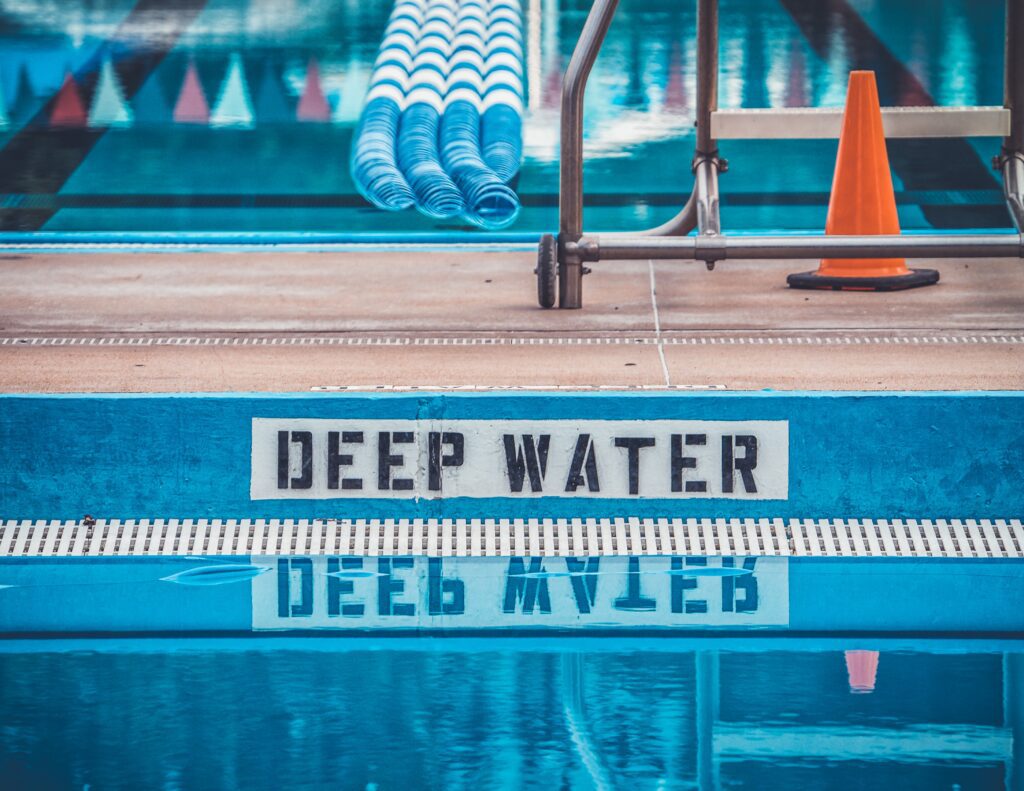 Swimming pool with sign that reads "Deep Water"