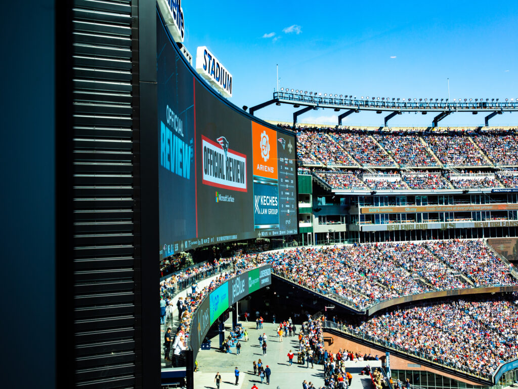 A picture of the video-board at Gillette Stadium with Keches Law Group featured in one corner.