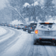 Cars in traffic during snowy weather conditions.